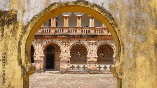 Abandoned and ruined bricks mansion archway © craigansibin