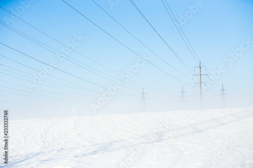 icy power lines on a frosty misty winter morning