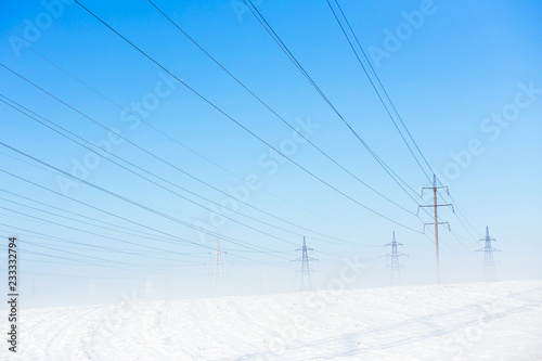 icy power lines on a frosty misty winter morning