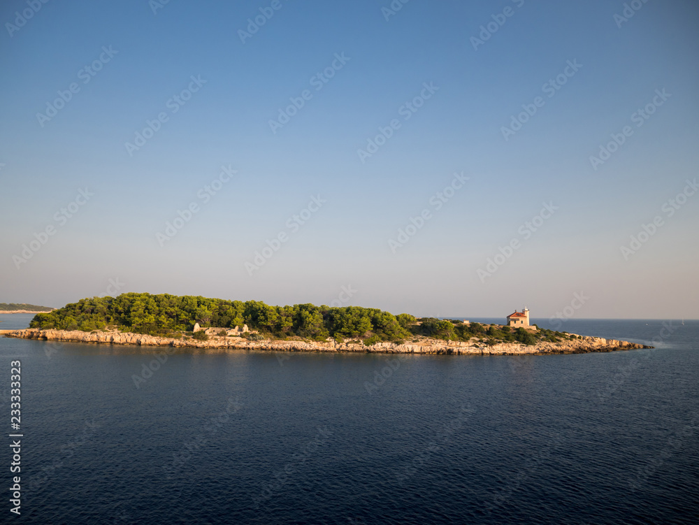 Small island with pine tree forest near island Vis in Croatia