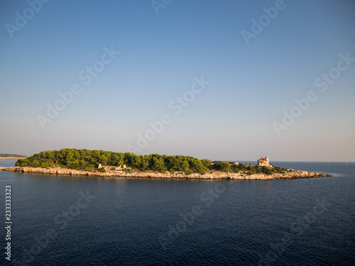 Small island with pine tree forest near island Vis in Croatia