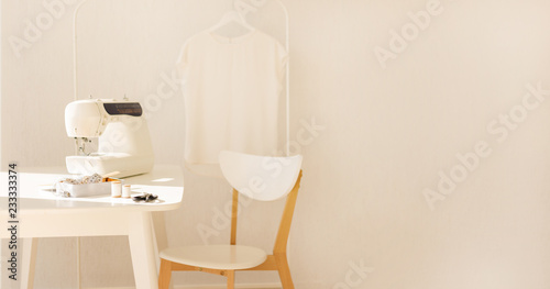 Workplace for sewing and needlework in a bright room with white furniture. © COLOR PHOTO
