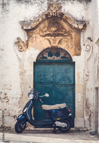 The traditional italian summer view of old street with scooter