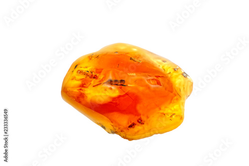 A beautiful polished shiny piece of amber with inclusions on  white background. Sunstone. Natural mineral for jewelers. Amber transparent yellow color. Amber background. Crystal. Natural mineral resin