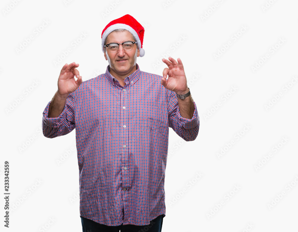 Handsome senior man wearing christmas hat over isolated background relax and smiling with eyes closed doing meditation gesture with fingers. Yoga concept.