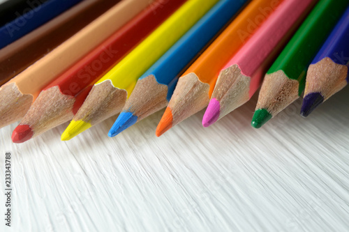 Set of colored pencils on light surface close up Selective focus