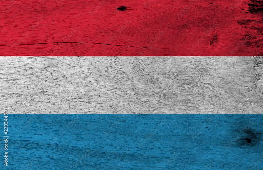 Flag of Luxembourg on wooden plate background. Grunge Luxembourg flag texture, horizontal red white and light blue. Flag of Luxembourg on wooden plate background. Grunge Luxembourg flag texture, horizontal red white and light blue.
