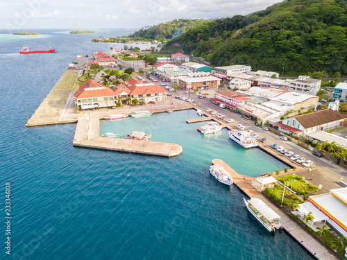 Aerial photo of Uturoa, French Polynesia: City centre, port harbour, and ferries to Tahaa. Raiatea, Leeward / Society Islands, Oceania, South Pacific