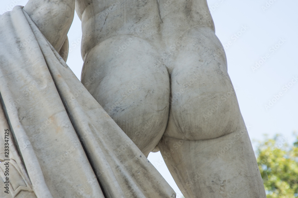 Male buttocks sculpture stone monument close up