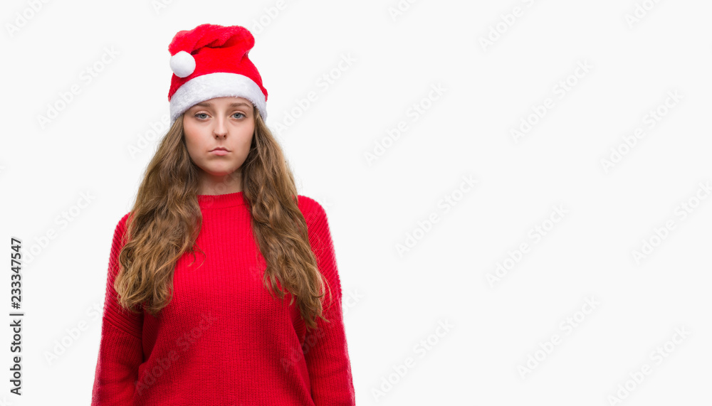 Young blonde woman wearing santa claus hat with a confident expression on smart face thinking serious Young blonde woman wearing santa claus hat with a confident expression on smart face thinking serious
