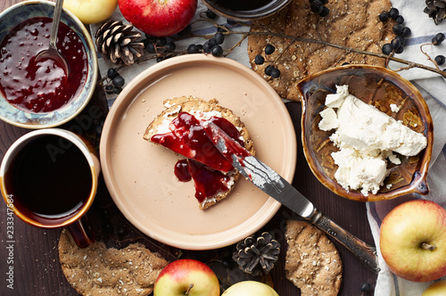 Obraz na płótnie Swedish rye crispbread with cream cheese and raspberry jam. Autumn and winter breakfast concept. w salonie