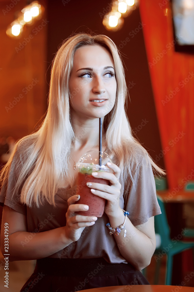 Beautiful Young Woman with Fruit smoothie