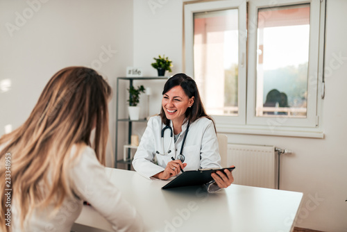 Young doctor and patient talking in the doctor's office.