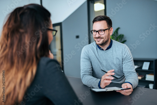 Female person having a job interview with a male recruiter. photo