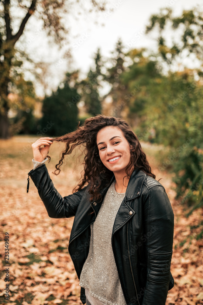 Portrait of smiling brunette in autumn park. Portrait of smiling brunette in autumn park.