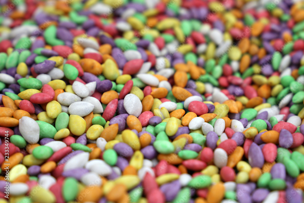 Sweet colorful candy. Sunflower seeds in sugar glaze, pile of candies for background Sweet colorful candy. Sunflower seeds in sugar glaze, pile of candies for background