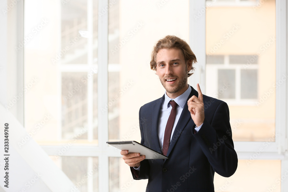 Successful businessman with tablet computer near window Successful businessman with tablet computer near window