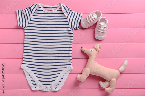 Baby clothes and toy on pin...
