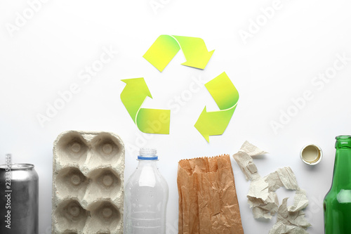 Different garbage with symbol of recycling on white background. Ecology concept