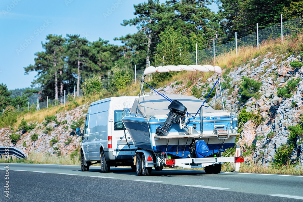 RV Camper Car with motorboat in Road in Slovenia