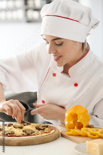 Young female chef cooking t...