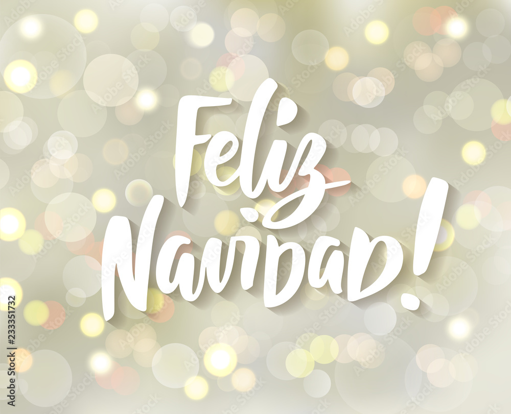 Feliz Navidad - spanish Merry Christmas hand drawn text. Holiday greetings quote. White and gold sparkling glowing lights. Background with bokeh effect.