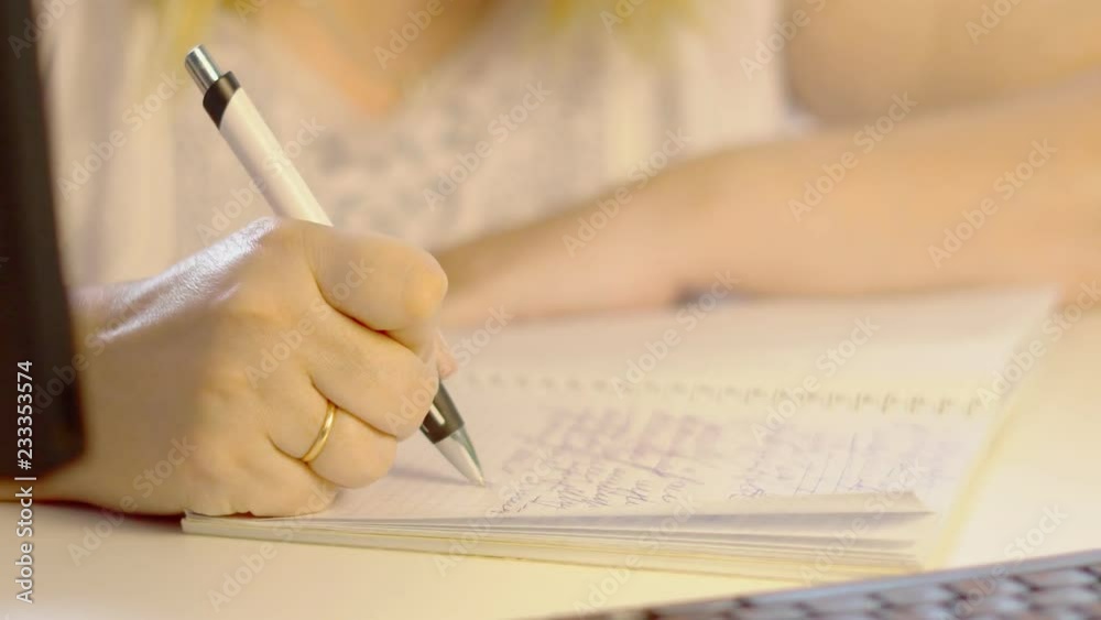 an elderly woman writes with a pen an elderly woman writes with a pen