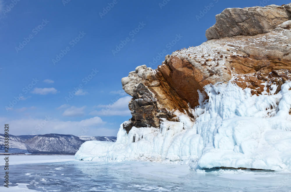  Baikal Lake in winter. Strait Small Sea (Maloe More). Beautiful icy rocks of bizarre shape on the edge of the stone island of Borga- Dagan