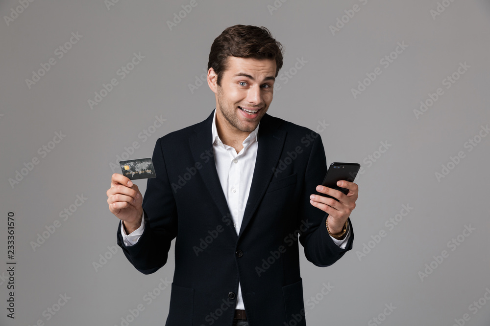 Portrait of a cheerful young businessman dressed in suit Portrait of a cheerful young businessman dressed in suit