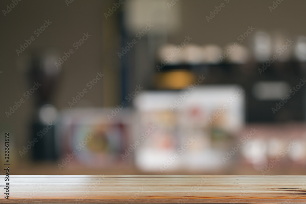 Wooden desk with Blurred of coffe's shop for abstract background