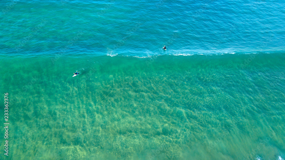 surfers at lineup aerial photo