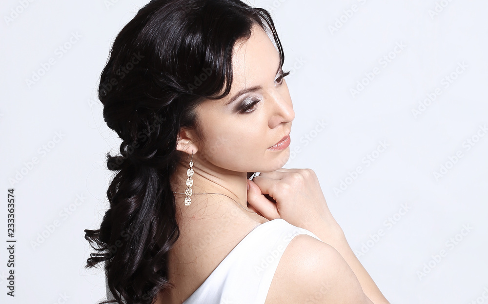 young woman model in white evening dress posing