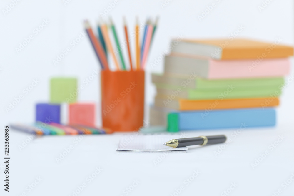 Fototapeta premium pen on blurred background of school supplies .photo with copy space