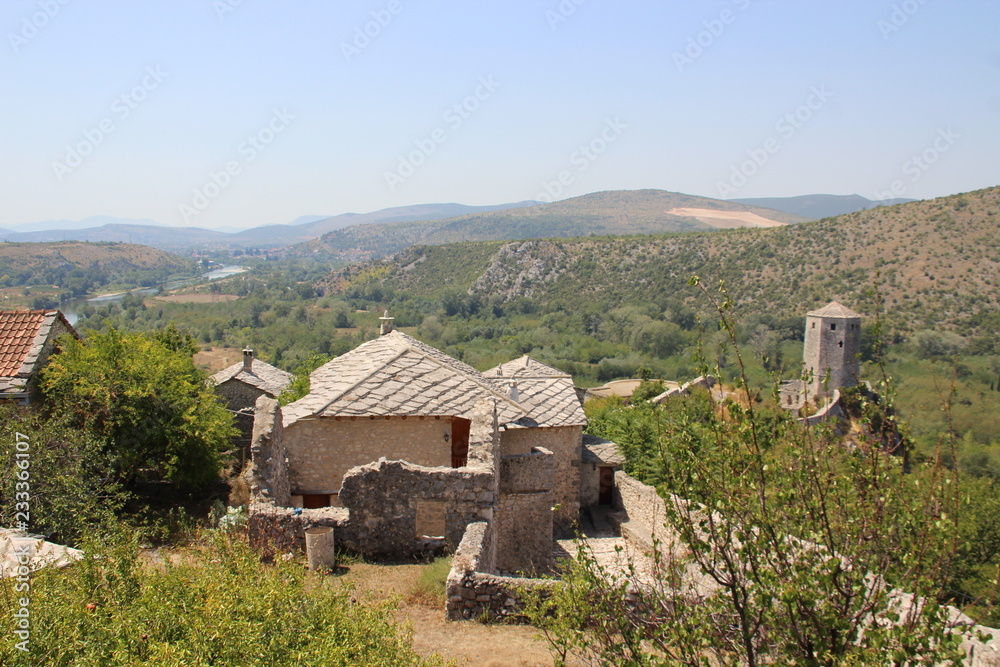 Pocitelj is a village in the Čapljina municipality in Bosnia and Herzegovina. The village is built in a natural karst amphiteatre along the Neretva river. Pocitelj is a village in the Čapljina municipality in Bosnia and Herzegovina. The village is built in a natural karst amphiteatre along the Neretva river.