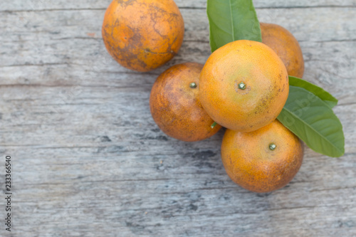 Closeup of fresh orange fruit on wooden table background