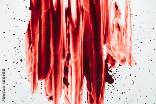 top view of blood blots smeared down on white