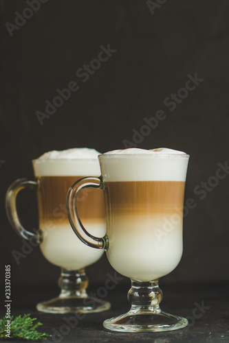 Latte - coffee with milk in a transparent cup on the table. Top view.