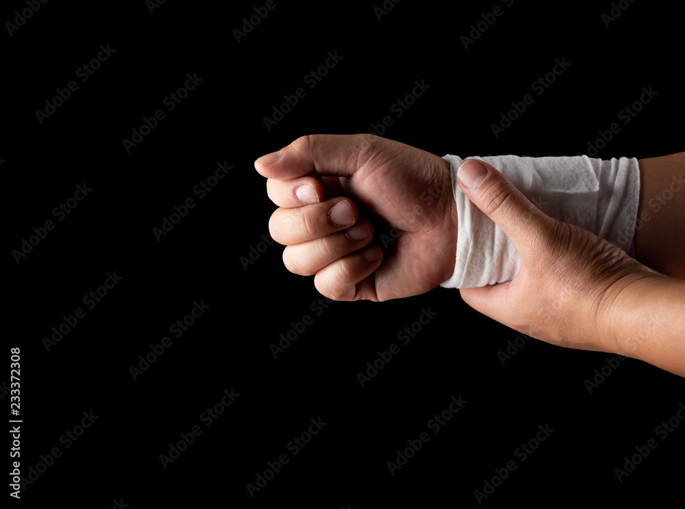 studio shot of man holding the right hand by his left hand