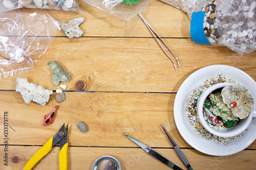 Crafting decoration hobby workshop with tools on wooden table.