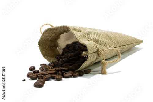 Coffee beans with small bag isolated white background closeup.