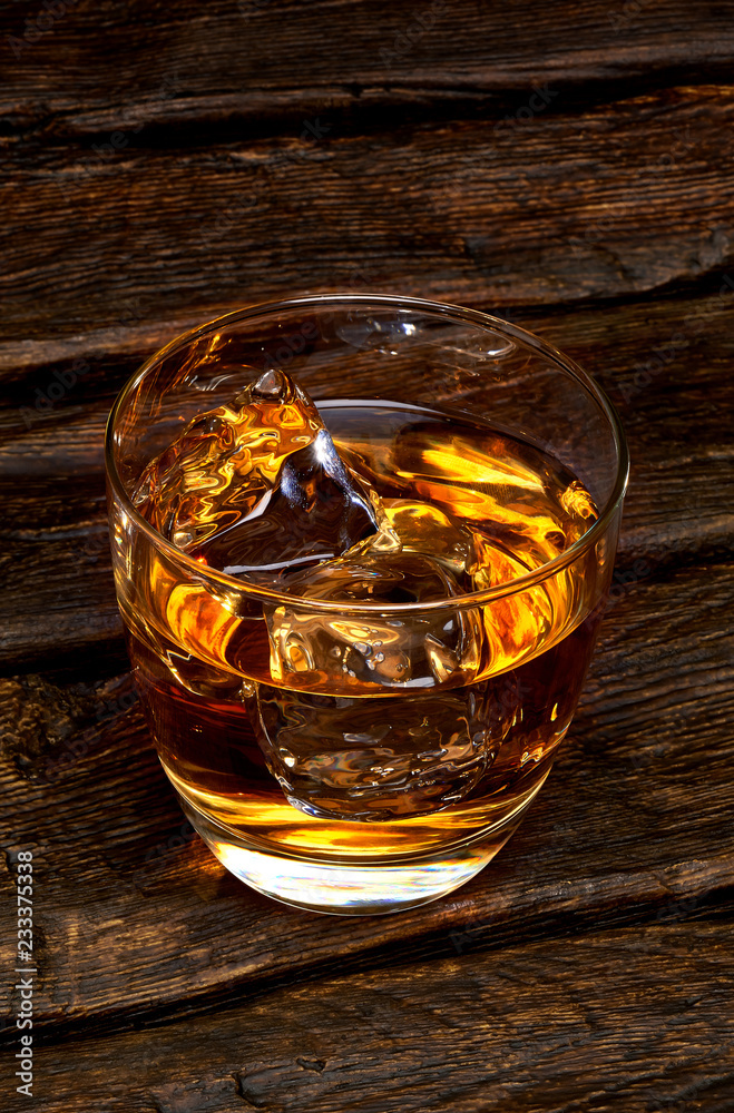 Whisky or whisky in glass on wooden table 