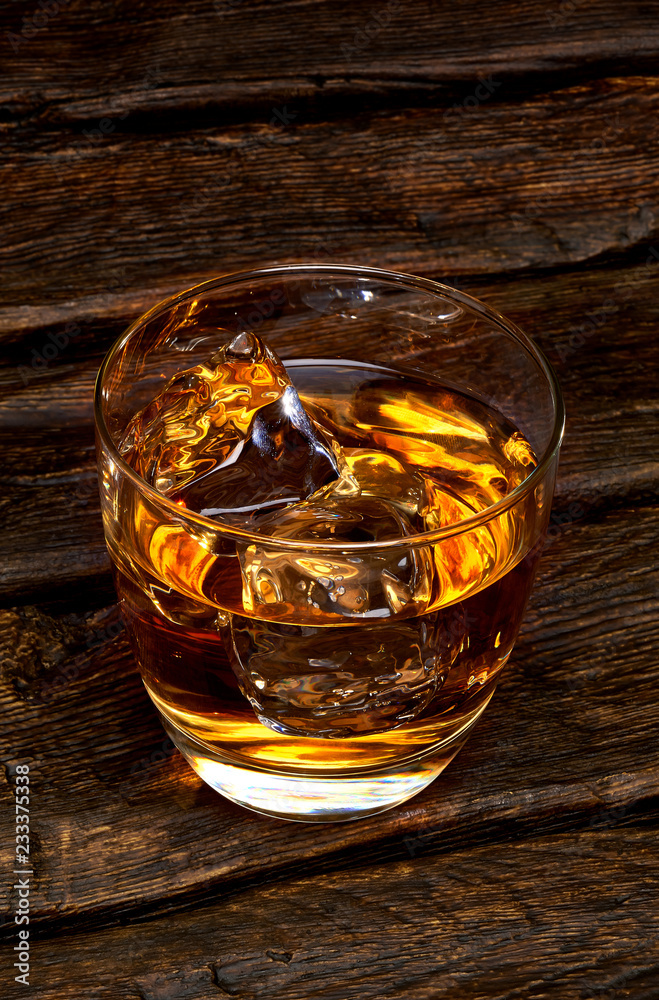 Whisky or whisky in glass on wooden table Whisky or whisky in glass on wooden table