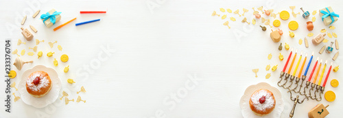 Banner of jewish holiday Hanukkah background with traditional spinnig top, menorah (traditional candelabra) and burning candles. photo