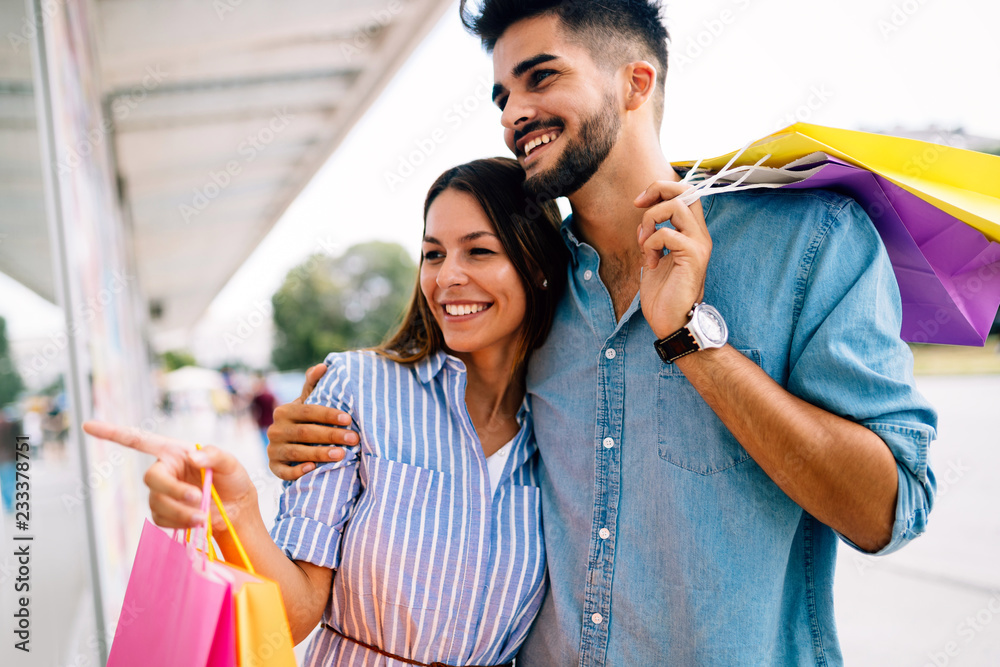 Happy attractive loving couple enjoy shopping together Happy attractive loving couple enjoy shopping together