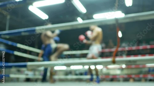 asian men thai boxing are punch and kick together with committee on canvas boxing stadium photo