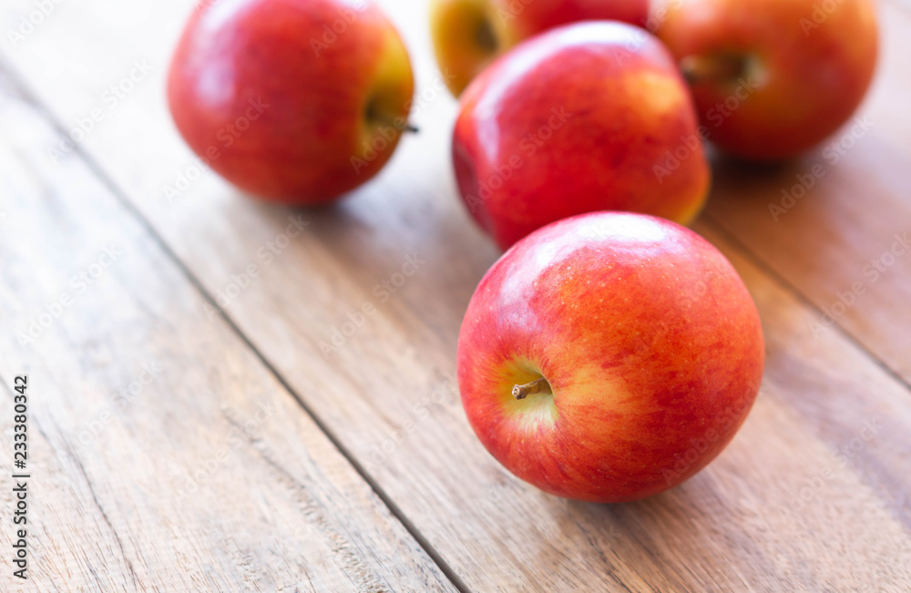 Closeup fresh red apples fruit on wood table background with light from out door, food healthy diet concept Closeup fresh red apples fruit on wood table background with light from out door, food healthy diet concept