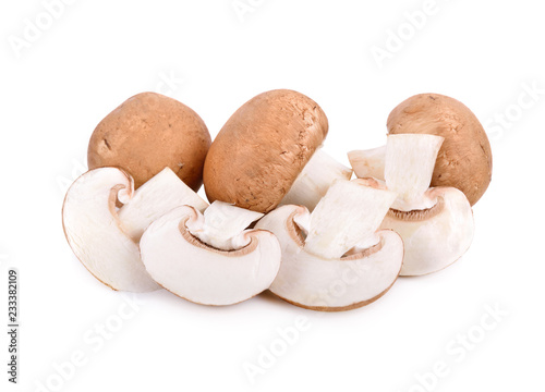 whole and sliced fresh swiss brown or champignon mushroom on white background