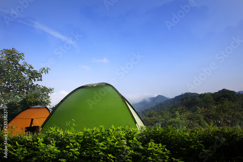 Tent camping in forest with blue sky and sunny sky photo