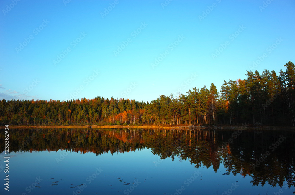 Nature of Sweden in autumn, Calm lake Kolpen with forest reflection, Peaceful outdoor image, Along the hiking trail Bruksleden in october