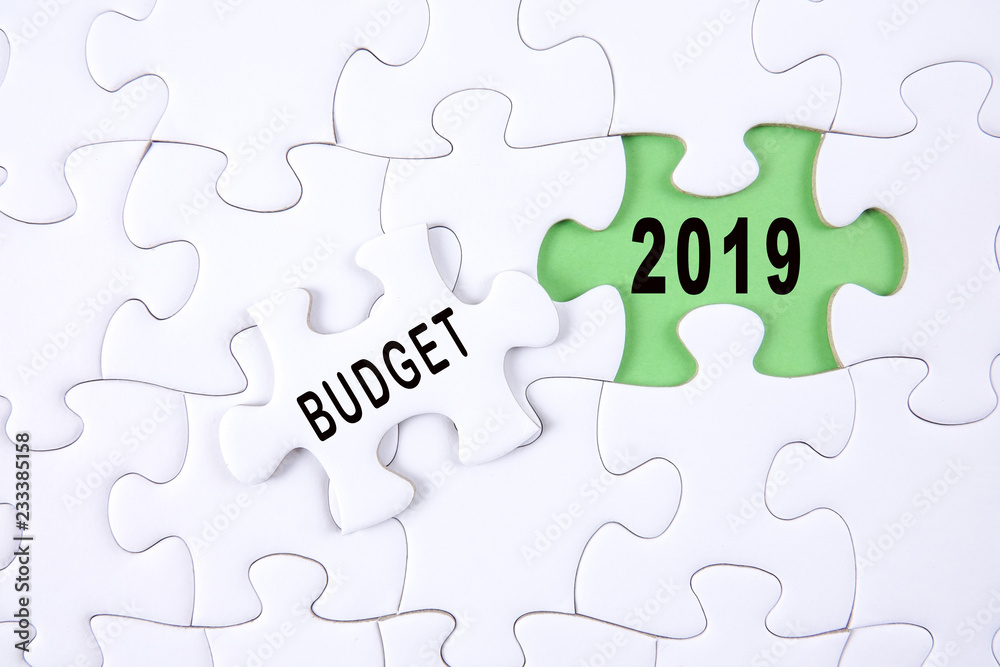 Business concept: 2019 BUDGET word on a jigsaw puzzle background. Business concept: 2019 BUDGET word on a jigsaw puzzle background.